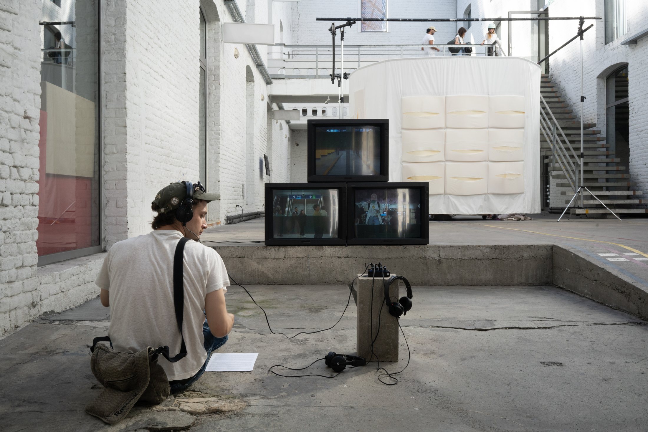A multi-screen audiovisual installation in the courtyard at Hotel Carrousel